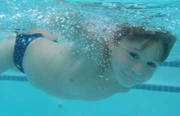 boy swimming like a dolphin