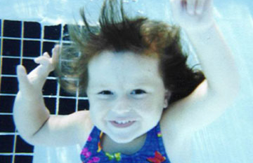 girl swimming under water